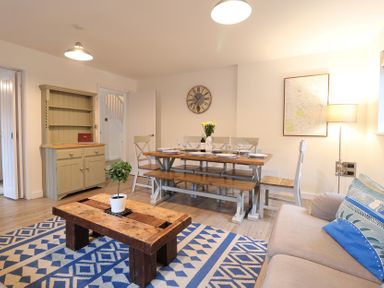 A dining room with a table and chairs at Corner Cottage, Thorpeness