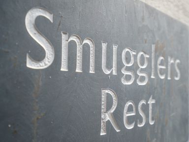 A close up of engraved text reading Smugglers Rest