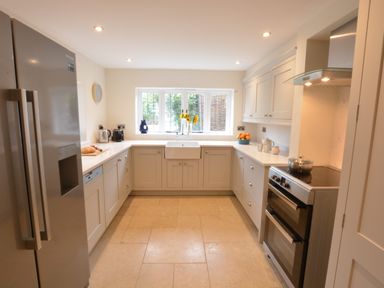 A kitchen with a refrigerator stove sink and cabinets at Old Valley Farm Walberswick