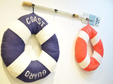 Two life rings hanging on a wall mounted wooden oar at The Smokehouse Cottage in Southwold
