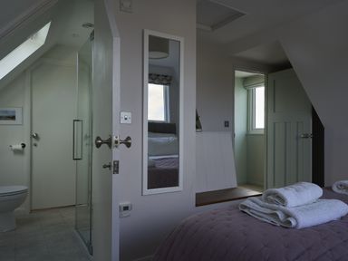 A bathroom with a shower and toilet at Harbour Lights in Southwold