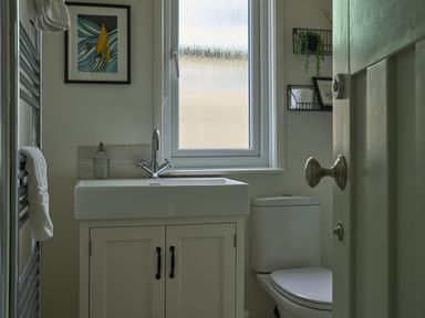A bathroom with a sink and toilet at Harbour Lights Southwold
