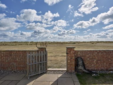 A gate and grass area at Harbour Lights in Southwold