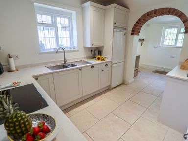 A kitchen with sink and refrigerator at High Ground, Reydon