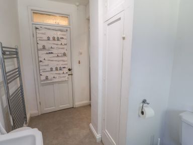 A bathroom with a towel radiator and a toilet at High Ground, Reydon