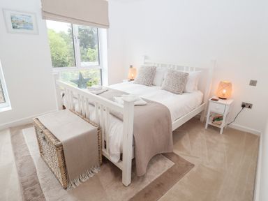A bedroom with a bed and bedside table at Salt Marsh House, Southwold