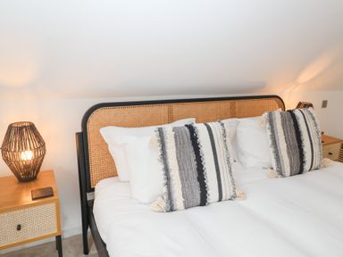 A bedroom with a bed and bedside table at Salt Marsh House, Southwold