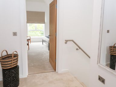 A hallway with steps and a door leading to a room at Salt Marsh House, Southwold