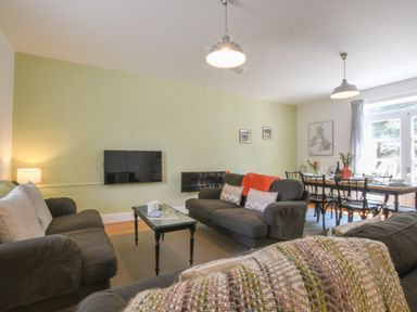 A living room with sofas coffee table and dining table with chairs at The Gallery Blythburgh near Southwold