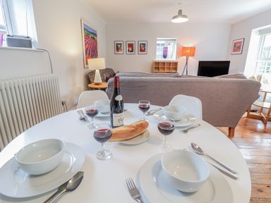 A dining area with a table set for a meal at Fig Cottage, Pettistree Near Woodbridge