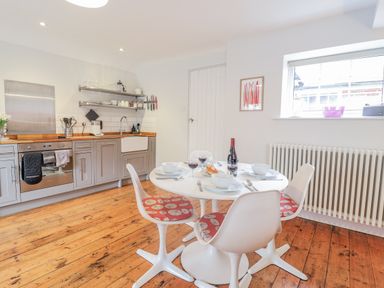 A kitchen with a dining table and chairs at Fig Cottage, Pettistree Near Woodbridge
