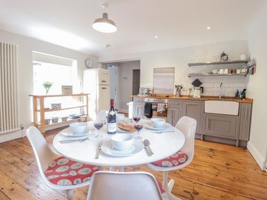 A kitchen with a dining table and chairs at Fig Cottage, Pettistree Near Woodbridge