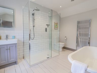 A bathroom with a shower, toilet, sink, and bathtub at Fig Cottage, Pettistree Near Woodbridge