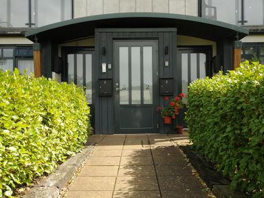 An entrance with two doors numbered 2 and 3 with mailboxes and plants on either side at Bluebell Retreat in Lostwithiel