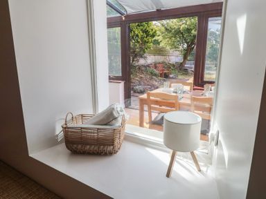 A dining room window with a basket and lamp at Candle Croft in Tolgus Mount near Redruth
