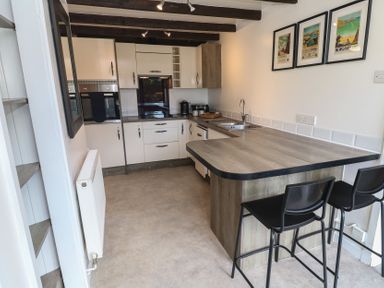 A kitchen with a countertop and appliances at Candle Croft in Tolgus Mount near Redruth