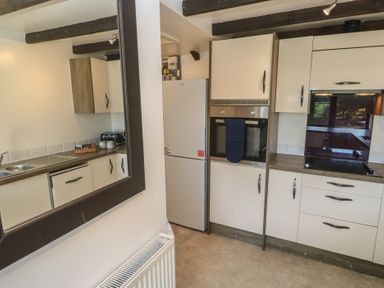 A kitchen with cabinets and appliances at Candle Croft near Tolgus Mount Redruth
