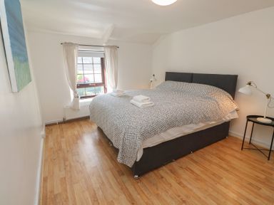 A bedroom with a bed and window at Candle Croft in Tolgus Mount near Redruth