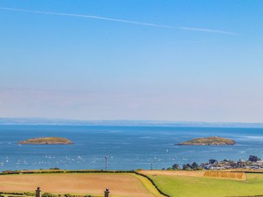 A coastal landscape with two small islands and fields near Watlands in Mynytho near Abersoch