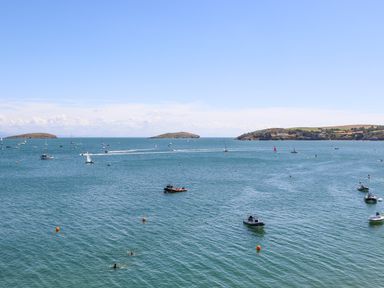 A bay with boats and small islands under a clear sky at Watlands in Mynytho near Abersoch