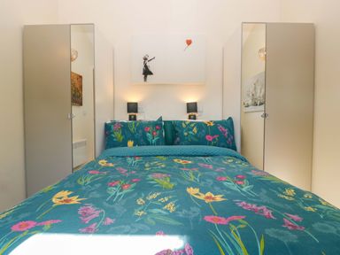A bedroom with a bed and two wardrobe doors at Bottom Lodge in Penhow