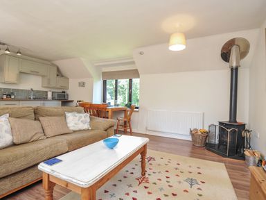 A living room with a sofa and coffee table at The Mews in Blisland