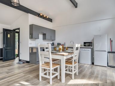 A kitchen with a table and chairs at The Annex in Wimborne Minster