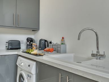 A kitchen with appliances and a sink at The Annex in Wimborne Minster