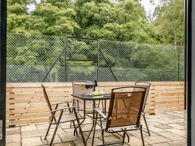 An outdoor patio with a table and chairs at The Annex in Wimborne Minster