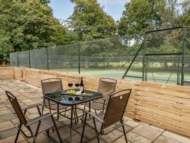 An outdoor patio with a table and chairs at The Annex in Wimborne Minster