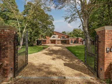 A property entrance with a gravel path and trees at The Annex in Wimborne Minster