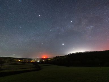 A night sky filled with stars over a town in a rural area at Creuddyn in Llanfihangel-y-Creuddyn near Aberystwyth