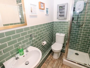 A bathroom with a sink mirror toilet and shower at The Coach House in St Florence