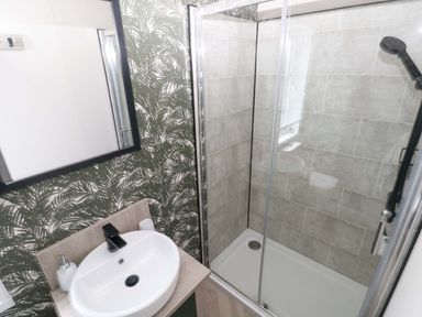 A bathroom with a sink and a shower at Oyster Lodge in Little Haven