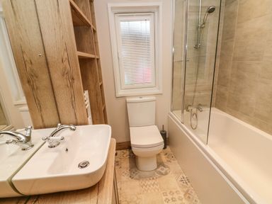 A bathroom with a sink mirror toilet bathtub and shower at Coniston View 9 Dock Acres near Tewitfield