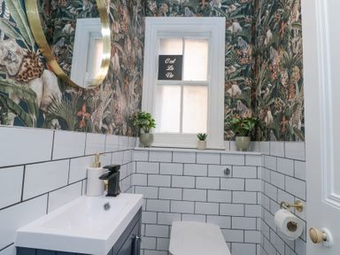 A bathroom with a window plants a sink and a toilet at Westbourne House Scarborough