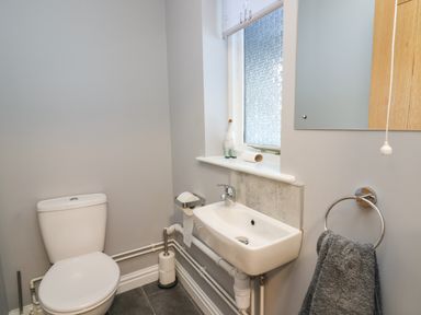 A small bathroom with a toilet sink and window at Pen Y Banc in Llanfaredd near Builth Wells