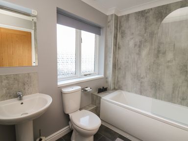 A bathroom with sink toilet and bathtub with shower at Pen Y Banc in Llanfaredd near Builth Wells