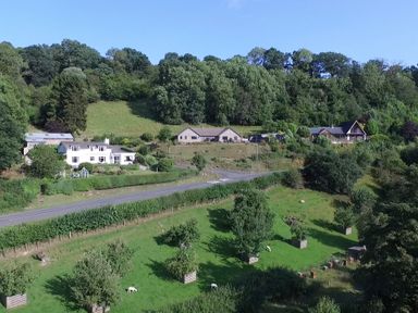 A landscape with houses trees and a road at Pen Y Banc in Llanfaredd near Builth Wells
