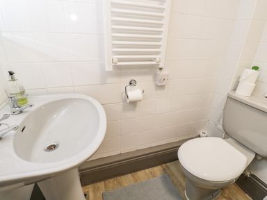 A bathroom with a sink toilet and towel rail at Paddock Cottage Nr Malmesbury