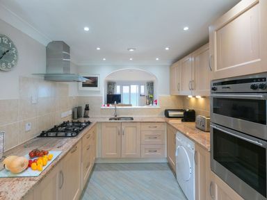 A kitchen with countertops appliances and a window view of the sea at Surf and Sand in Carbis Bay