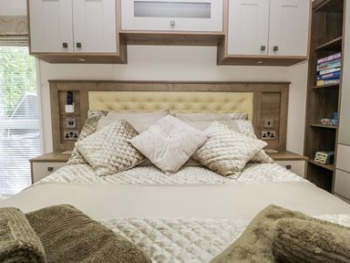 A bedroom with a bed and bedside tables at Lilac Lodge Carnforth