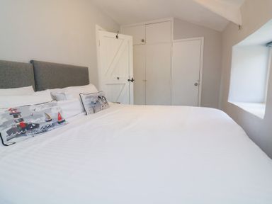 A bedroom with a bed and pillows at Wayside near Kingsbridge
