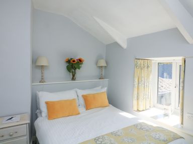 A bedroom with a bed and window at Wayside near Kingsbridge