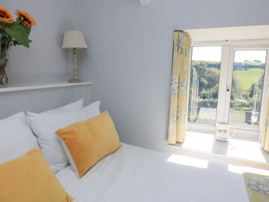 A bedroom with a bed and a window at Wayside near Kingsbridge