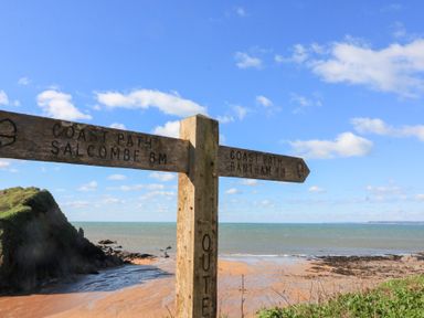 A signpost indicating the coast path to Salcombe and Bantham near Kingsbridge