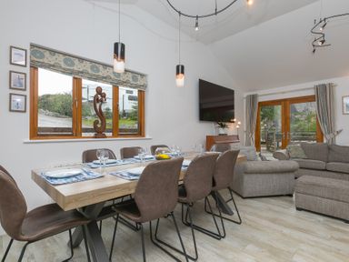 A dining room with a table and chairs at Branock Tor Down Quarry St Breward