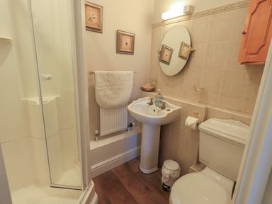 A bathroom with a shower enclosure sink toilet and towel rack at Peak View in Keswick