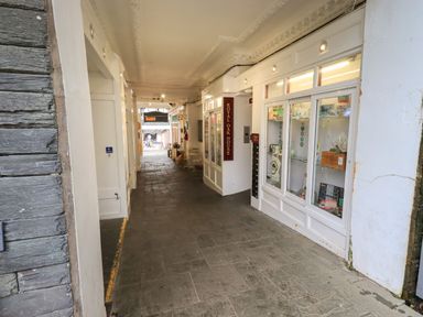 A corridor with glass display windows and a sign reading royal oak house at Peak View in Keswick