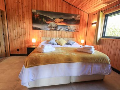 A bedroom with a double bed and two bedside lamps at Greengarth in Yanwath near Penrith